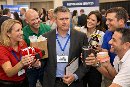 Claims adjuster evaluating restoration vendors at a property damage claims adjuster conference.