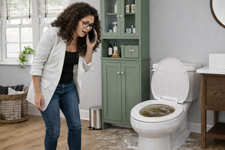 A Rhode Island homeowner reacts to an overflowing toilet as dirty water spills onto the bathroom floor