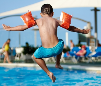 kid jumping in pool